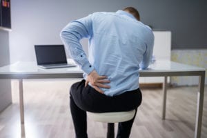 Businessman Suffering From Back Pain while at work