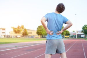 A male runner with back pain