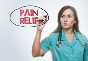Pain Management Doctor writing Pain relief on Board