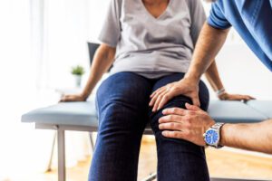 Doctor checking out the joint of a female patient who possibly have Osteoarthritis