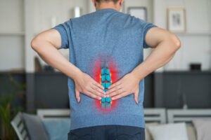 man experiencing low back pain triggers at home.