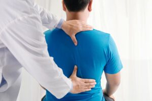 Man getting his spine examined by a medical professional hoping to get tips for the management of his degenerative disc disease.